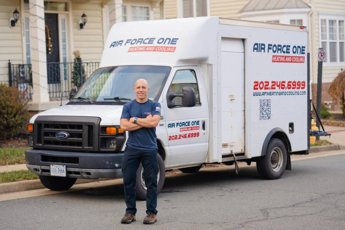 Jim, owner of Air Force One Heating and Cooling, standing in front of the company service truck on a Northern Virginia street